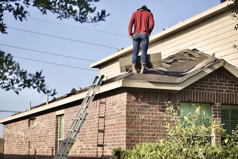 Professional roofer working on a residential roof in Prosper